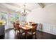 Elegant dining room with hardwood floors, large windows, and stylish chandelier at 6140 Stillwood Ln, Cumming, GA 30041