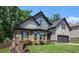 Charming two-story home featuring a well-manicured lawn and a mix of brick and siding elements at 6140 Stillwood Ln, Cumming, GA 30041