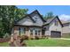 Charming two-story home with manicured lawn, brick accents, and a two-car garage at 6140 Stillwood Ln, Cumming, GA 30041