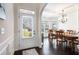 Welcoming foyer with hardwood floors, arched doorway, and view into formal dining room at 6140 Stillwood Ln, Cumming, GA 30041