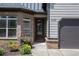 Welcoming front entrance features a glass-paneled door and vibrant landscaping at 6140 Stillwood Ln, Cumming, GA 30041