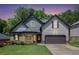 Charming two-story home with a well-manicured lawn, brick accents, and an attached two-car garage at 6140 Stillwood Ln, Cumming, GA 30041