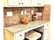 Convenient home office space with granite countertops, storage and stylish tile backsplash at 6140 Stillwood Ln, Cumming, GA 30041