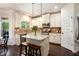 Bright kitchen with granite countertops, stainless steel appliances, a kitchen island, and hardwood floors at 6140 Stillwood Ln, Cumming, GA 30041