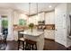 Bright kitchen with white cabinets, granite countertops, stainless appliances, and central island at 6140 Stillwood Ln, Cumming, GA 30041