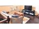 Comfortable living room with a plush sofa, a large television, and dark wood flooring at 6140 Stillwood Ln, Cumming, GA 30041