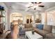 Open-concept living room with hardwood floors, fireplace, and arched doorway to kitchen at 6140 Stillwood Ln, Cumming, GA 30041
