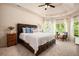 Spacious main bedroom with trey ceilings, carpeted floors, and bright windows at 6140 Stillwood Ln, Cumming, GA 30041