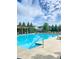 Inviting community pool with ample seating and a pergola, perfect for relaxation and recreation at 6140 Stillwood Ln, Cumming, GA 30041