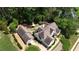Aerial view of a home with a well-manicured lawn, mature trees, and a detached garage at 122 Griffin Way, Canton, GA 30115