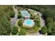 Aerial view showcasing the community pool, tennis courts, and playground amidst lush landscaping at 122 Griffin Way, Canton, GA 30115
