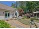 Landscaped backyard featuring a wooden deck with chairs, lush lawn, a rock garden, and mature trees at 122 Griffin Way, Canton, GA 30115