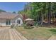 Expansive backyard featuring multiple wooden decks, lush landscaping, and a tranquil water feature under an umbrella at 122 Griffin Way, Canton, GA 30115