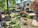 A beautiful backyard includes a waterfall and mature trees creating a serene outdoor oasis at 122 Griffin Way, Canton, GA 30115