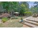 Spacious backyard with wooden deck, koi pond, lush landscaping and entertaining areas at 122 Griffin Way, Canton, GA 30115