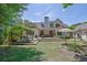 Large backyard features a spacious deck with an umbrella, dining area, and grassy lawn at 122 Griffin Way, Canton, GA 30115