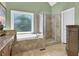 Modern bathroom featuring a soaking tub, glass enclosed shower, and neutral color scheme at 122 Griffin Way, Canton, GA 30115