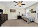Comfortable bedroom with neutral decor, ceiling fan, and natural light from the windows at 122 Griffin Way, Canton, GA 30115