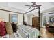 Bedroom with four poster bed, tray ceiling, hardwood floors, and access to the porch at 122 Griffin Way, Canton, GA 30115