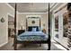 Bedroom featuring a four-poster bed and outside access at 122 Griffin Way, Canton, GA 30115