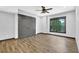Bright bedroom with wood floors, a large window, and a spacious closet for ample storage at 122 Griffin Way, Canton, GA 30115