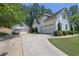 Exterior of the home with a three-car garage, car and landscaped yard at 122 Griffin Way, Canton, GA 30115
