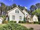 Charming two-story home features a well-manicured lawn, lush greenery, and neutral siding at 122 Griffin Way, Canton, GA 30115