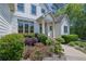 Charming home exterior with well-maintained landscaping, colorful flower beds, and classic architectural details at 122 Griffin Way, Canton, GA 30115