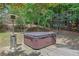 Backyard deck featuring a hot tub with a heater, surrounded by trees at 122 Griffin Way, Canton, GA 30115