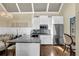 Bright kitchen features white cabinets, granite counters, stainless steel appliances, and stylish pendant lighting at 122 Griffin Way, Canton, GA 30115