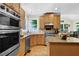 Modern kitchen featuring stainless steel appliances, granite countertops, wood floors and custom cabinets at 122 Griffin Way, Canton, GA 30115