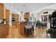 Open-concept kitchen and dining area features wood cabinets, granite countertops, pendant lighting, and wood floors at 122 Griffin Way, Canton, GA 30115