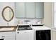 Well-organized laundry room featuring a sink, washer, dryer, and stylish shelving at 122 Griffin Way, Canton, GA 30115