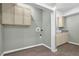 Functional laundry room with cabinetry, sink, and tile flooring at 122 Griffin Way, Canton, GA 30115