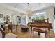 Bright living area features a piano, wainscoting, and hardwood floors at 122 Griffin Way, Canton, GA 30115