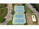 Aerial view of community tennis courts with blue playing surfaces and green surround at 122 Griffin Way, Canton, GA 30115