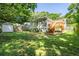 View of backyard with wooden deck, shed, and lush green lawn at 166 Martha Ave, Atlanta, GA 30317