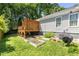 Landscaped backyard with a raised deck, garden beds, and mature trees, creating a private and serene outdoor space at 166 Martha Ave, Atlanta, GA 30317