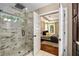 Stunning primary bathroom featuring a glass shower with stylish tile work adjacent to the bright, connected bedroom at 166 Martha Ave, Atlanta, GA 30317