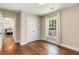 Comfortable bedroom with hardwood floors and a view leading to the bright primary bedroom and a built-in closet at 166 Martha Ave, Atlanta, GA 30317