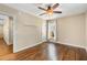 Cozy bedroom with hardwood floors, a ceiling fan, and a window providing natural light and backyard views at 166 Martha Ave, Atlanta, GA 30317