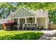 Charming craftsman home with welcoming front porch, manicured lawn and mature landscaping at 166 Martha Ave, Atlanta, GA 30317
