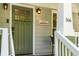 Close-up of the inviting front door with stylish details and a 'Welcome to Kirkwood' sign at 166 Martha Ave, Atlanta, GA 30317