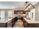 Kitchen featuring stainless appliances, dark wood cabinets, large island, and view into breakfast room at 166 Martha Ave, Atlanta, GA 30317
