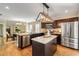 Kitchen featuring stainless appliances, dark wood cabinets, large island, and view into breakfast room at 166 Martha Ave, Atlanta, GA 30317