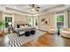 Spacious main bedroom with tray ceilings, hardwood floors, seating and ample natural light at 166 Martha Ave, Atlanta, GA 30317