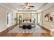 Spacious main bedroom with tray ceilings, hardwood floors, ensuite bathroom and ample natural light at 166 Martha Ave, Atlanta, GA 30317