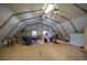Spacious unfinished attic with exposed rafters, wood floor, multiple windows, and multiple ceiling fans at 191 White Oak Church Rd, Dallas, GA 30157