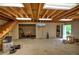 Unfinished basement featuring exposed wood ceiling, cement floors, and open layout, providing ample potential at 191 White Oak Church Rd, Dallas, GA 30157
