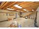 Unfinished basement with concrete flooring and exposed wood ceiling at 191 White Oak Church Rd, Dallas, GA 30157